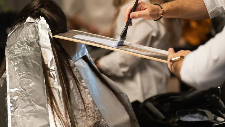 Hair colour being applied with foils in a salon