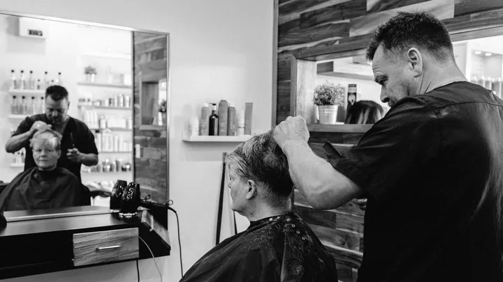 Senior client receiving a haircut in a contemporary salon
